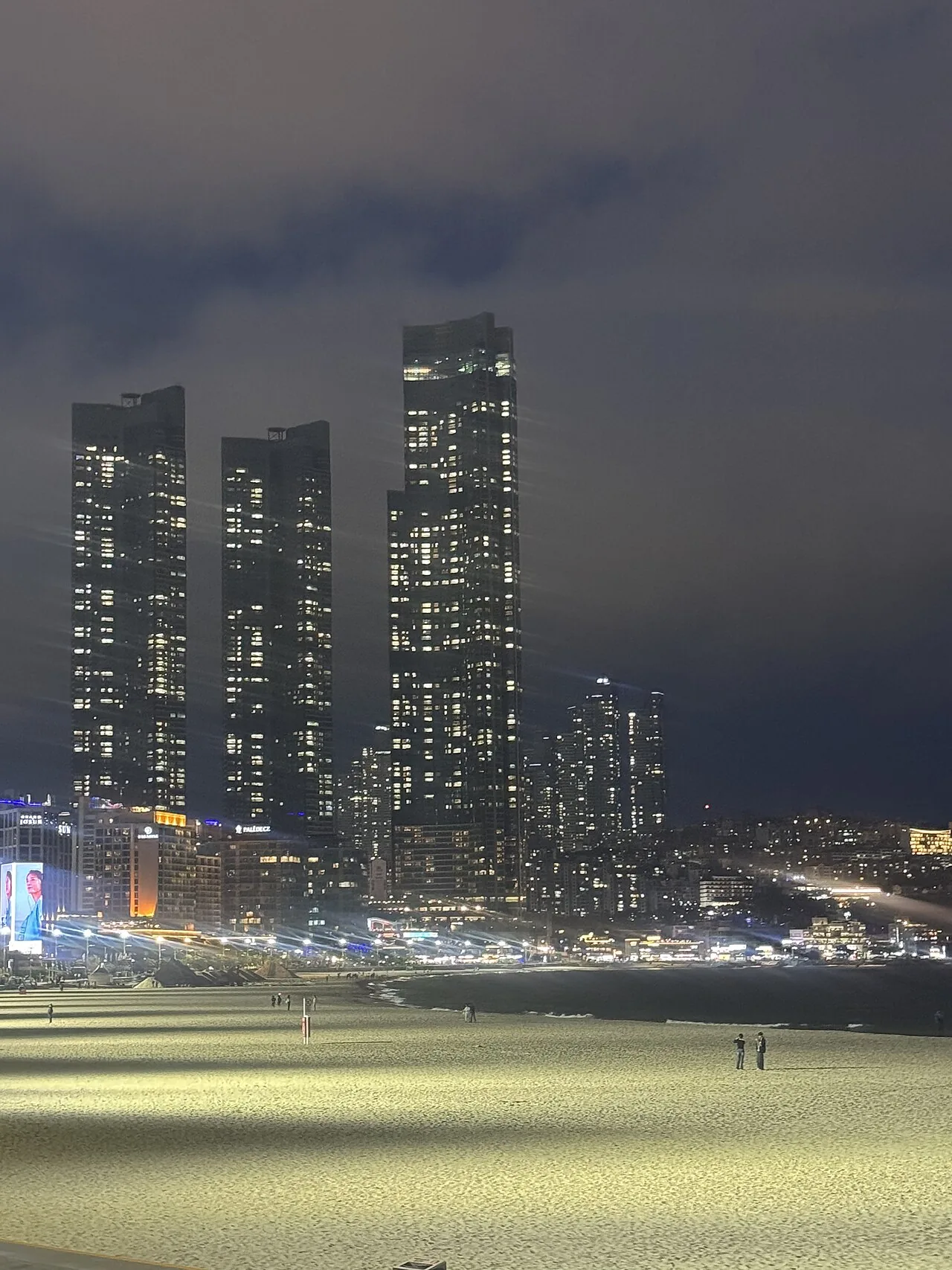 Haeundae Beach at night with the city skyline lit up, Busan