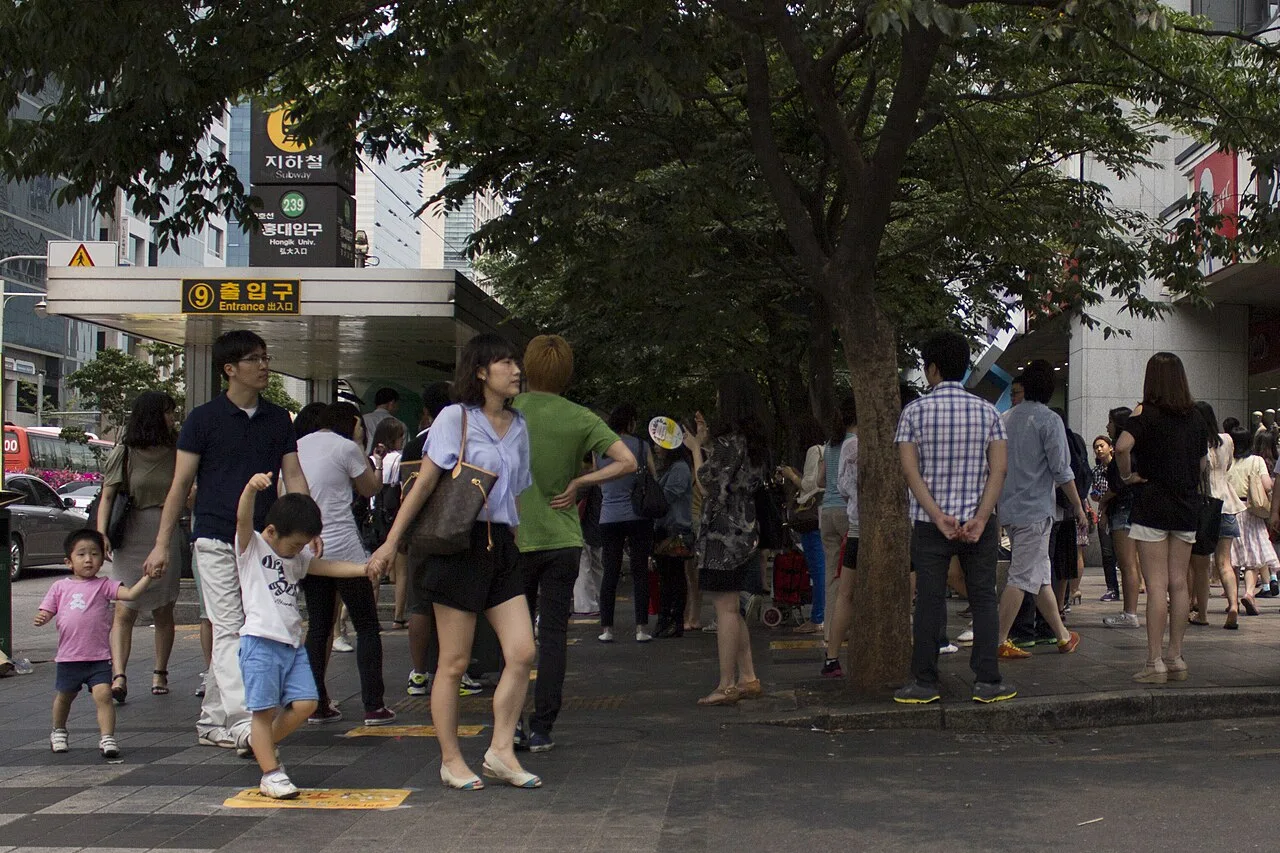 Exit 9 of Hongik University Station with people walking out onto the street