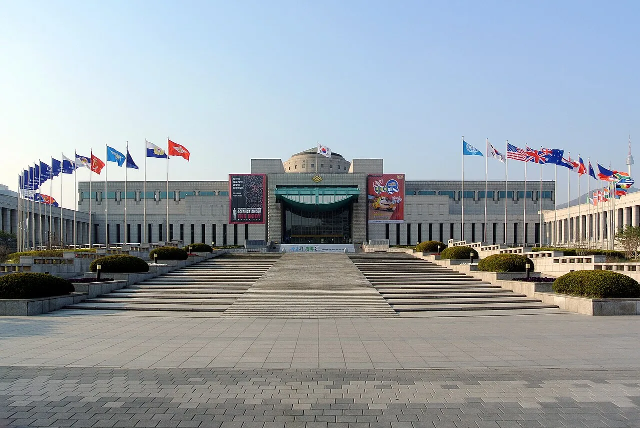The War Memorial of Korea main building with flags along a wide plaza
